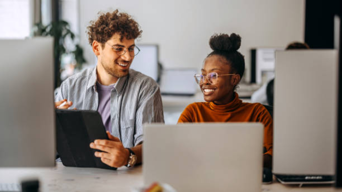 Two young colleagues working together at modern office